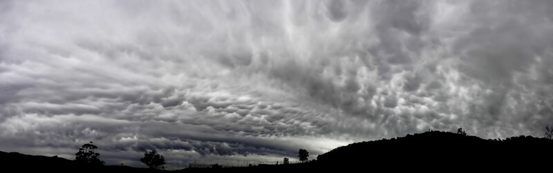 dramatic storm clouds over hills