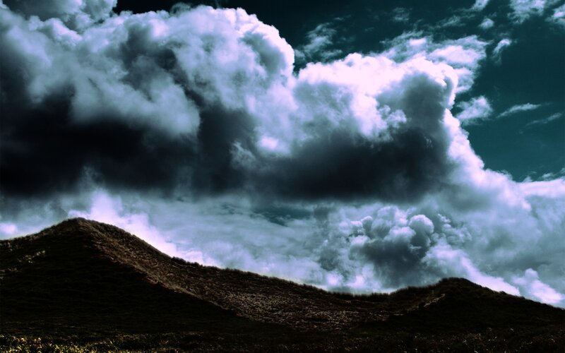 Dramatic storm clouds over hills