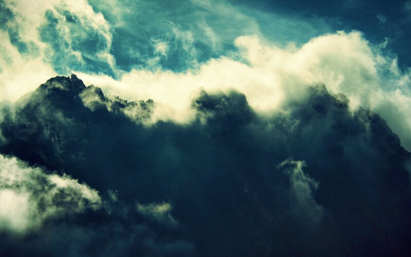 dramatic storm clouds over mountains