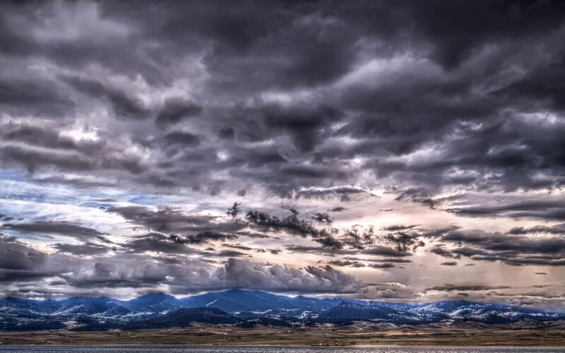 dramatic storm clouds over mountains