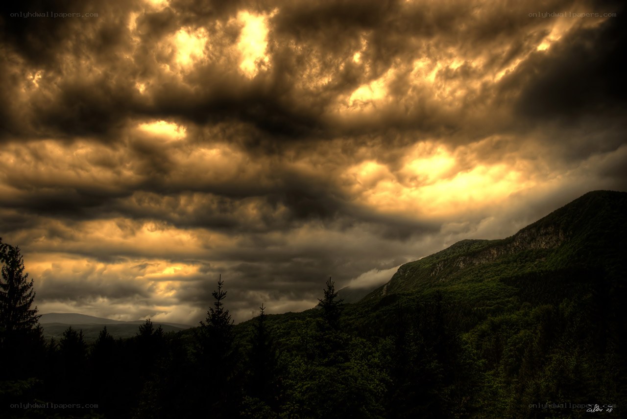Dramatic storm clouds over mountains