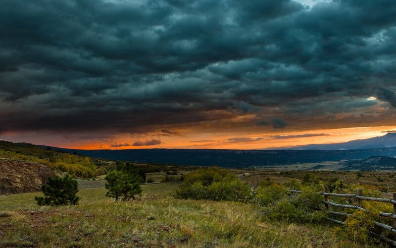 Dramatic Storm Clouds over Valley — Orange
