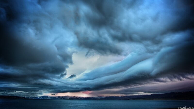 Dramatic storm clouds over water