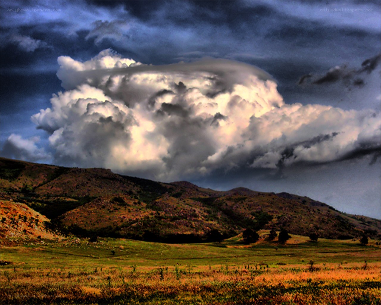 Dramatic storm over rolling hills