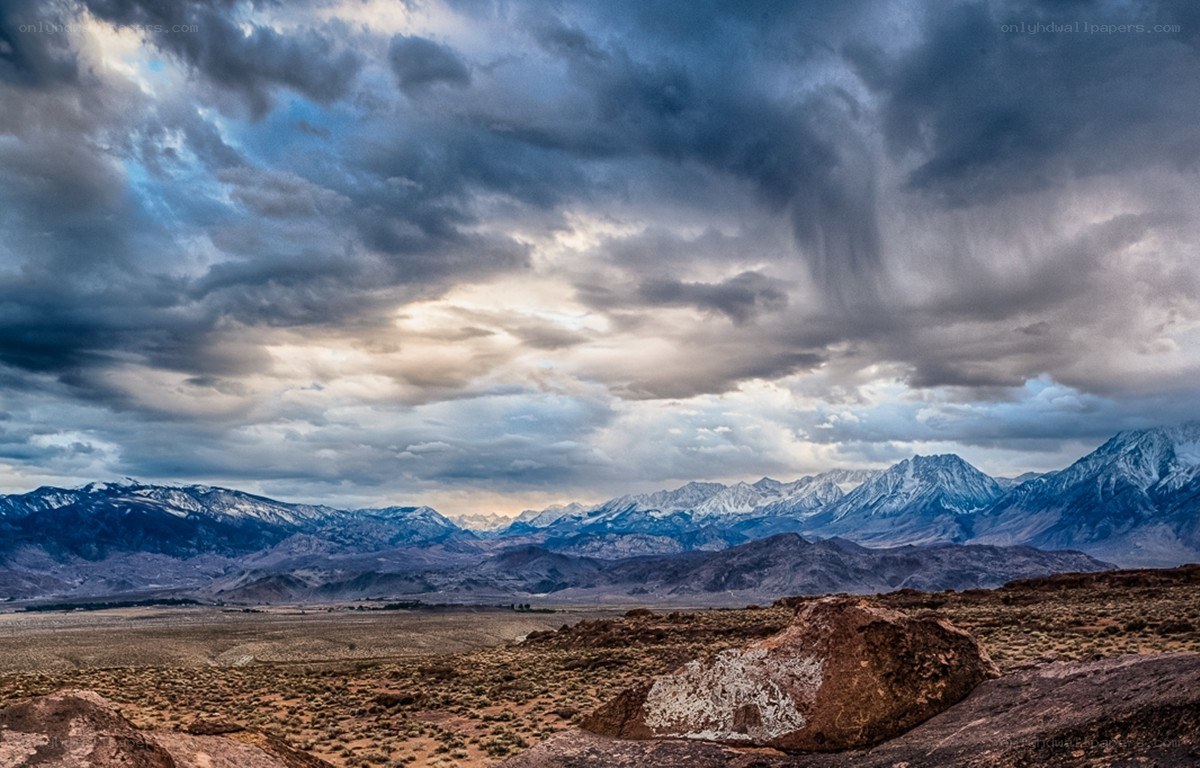 Dramatic storm over snowy mountains