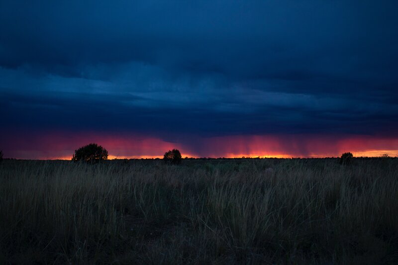 Dramatic stormy sunset over grassland