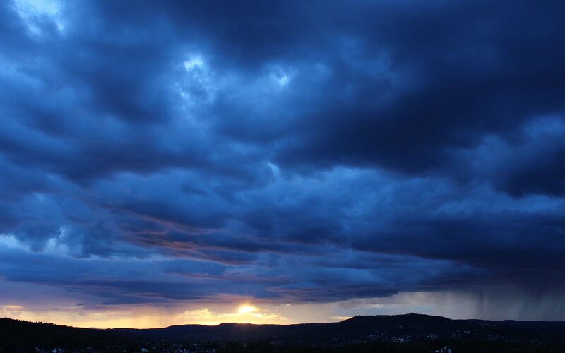 Dramatic stormy sunset over hills