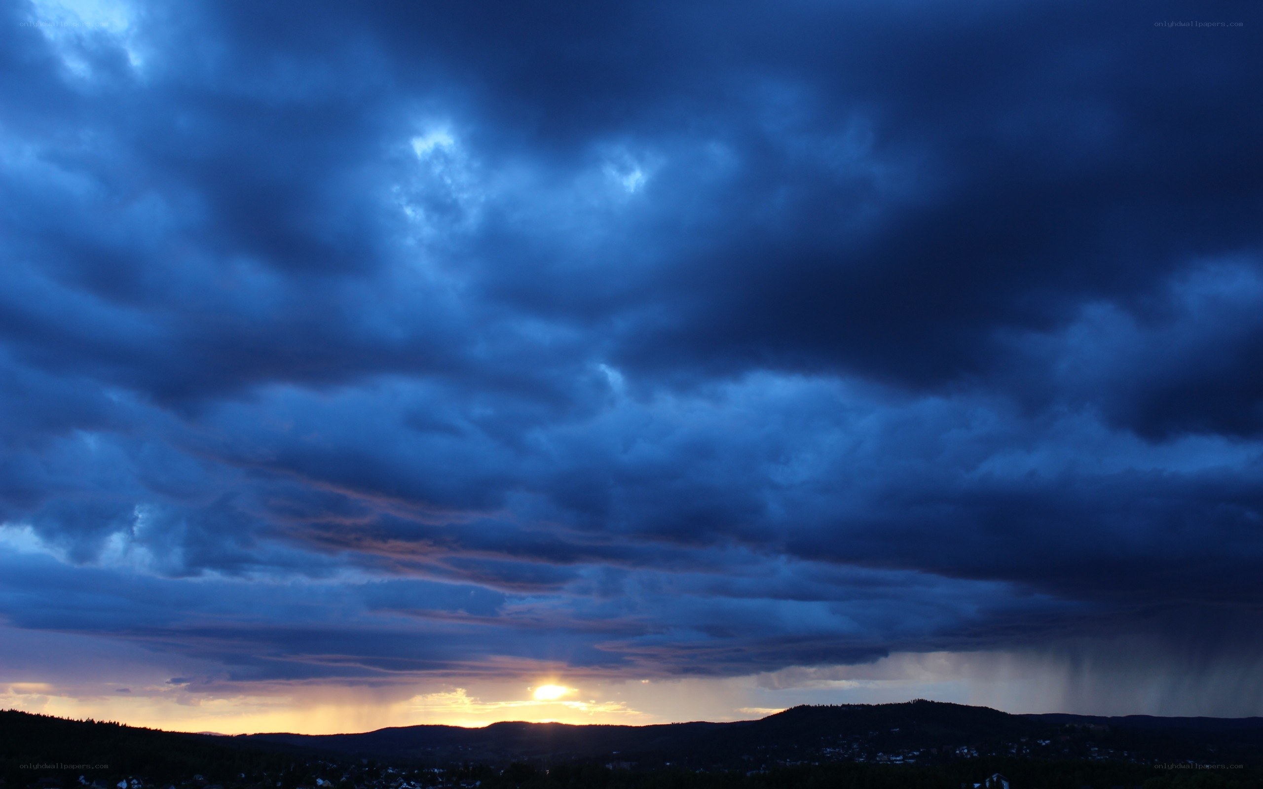 Dramatic stormy sunset over hills