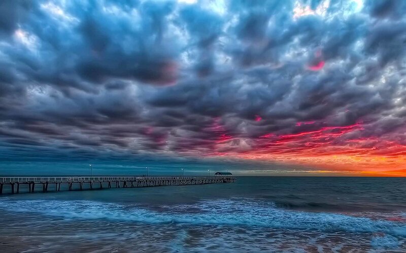Dramatic sunset over a pier