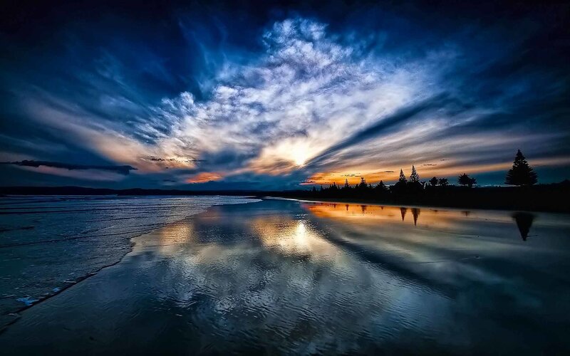 Dramatic sunset over a reflective beach