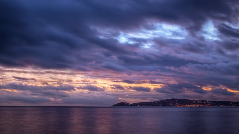 Dramatic sunset over coastal city