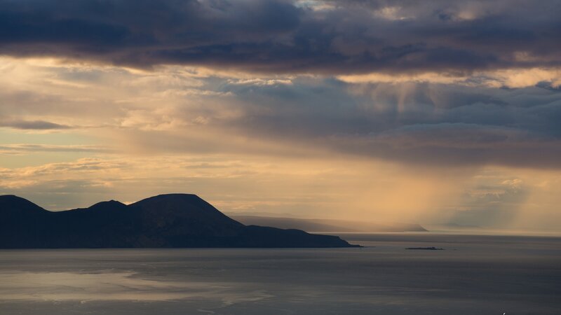 Dramatic sunset over coastal hills
