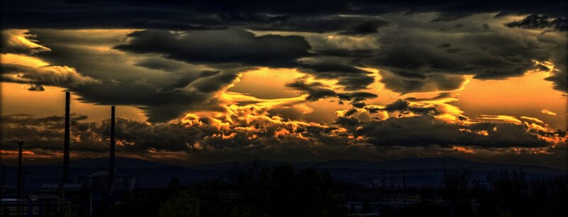 dramatic sunset over industrial city