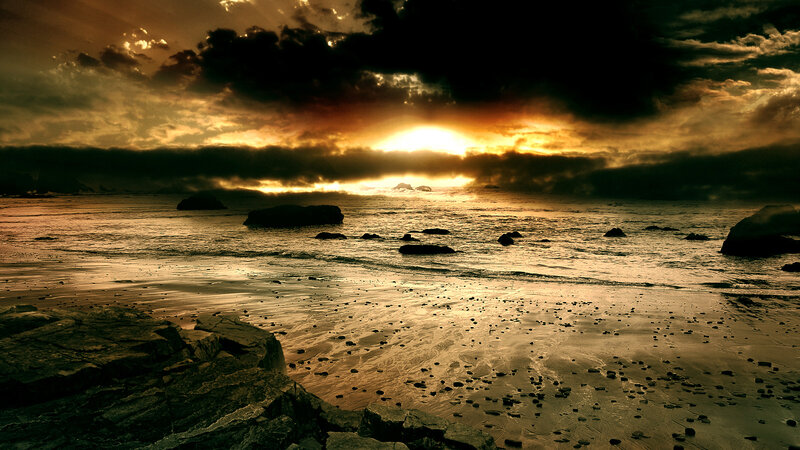 dramatic sunset over rocky beach