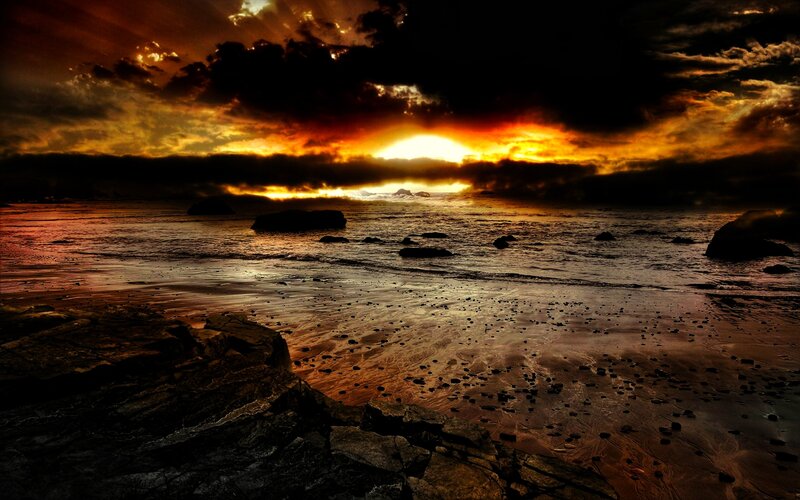Dramatic sunset over rocky beach