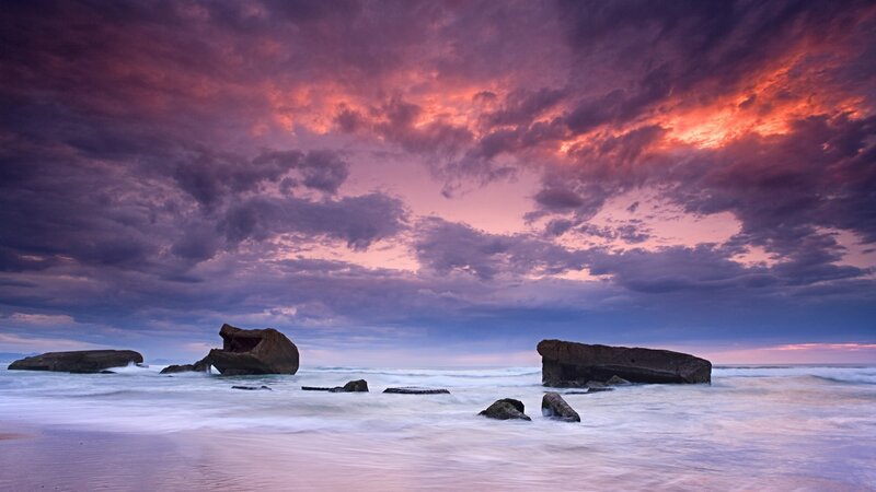 dramatic sunset over rocky beach