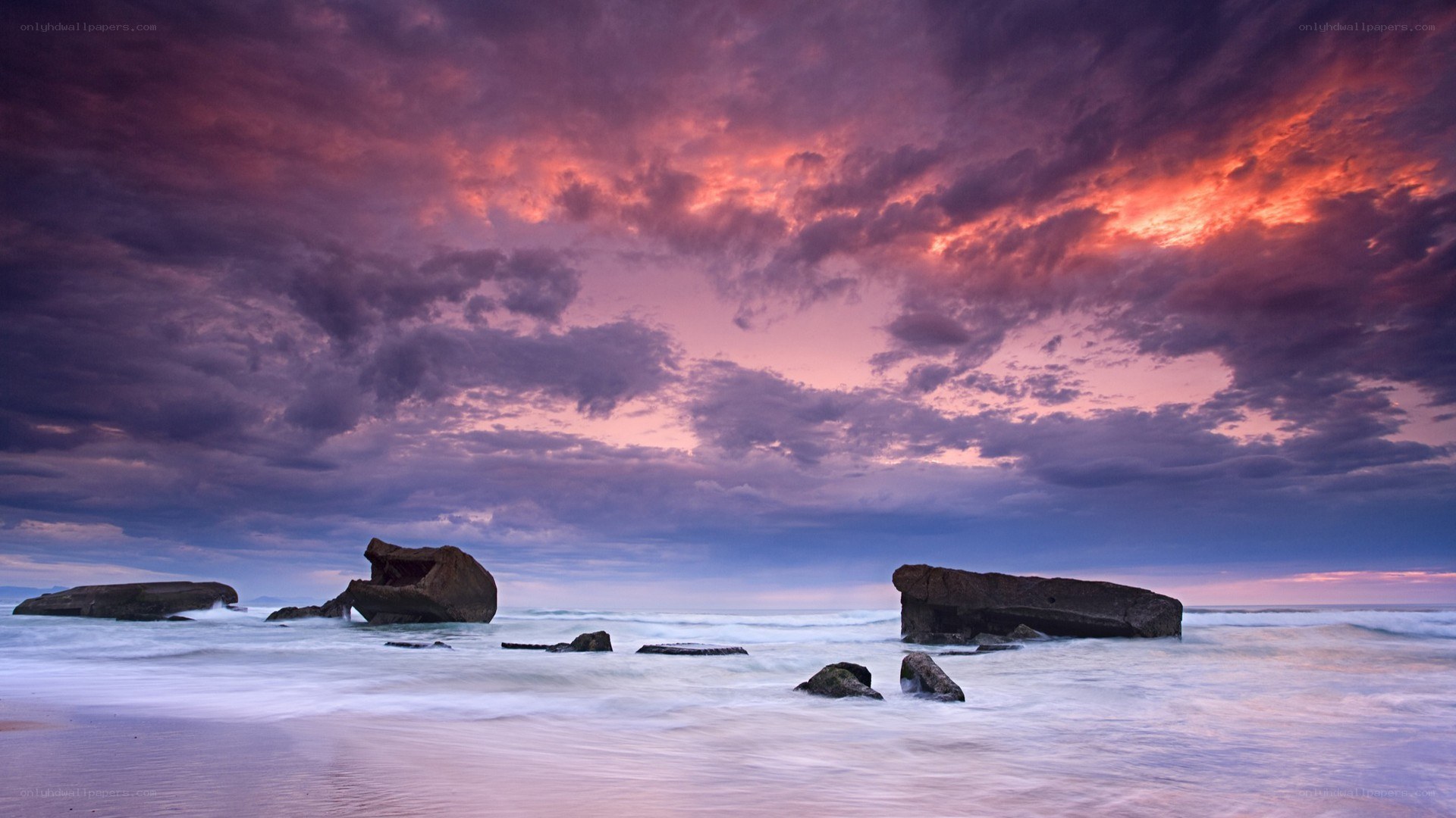 dramatic sunset over rocky beach