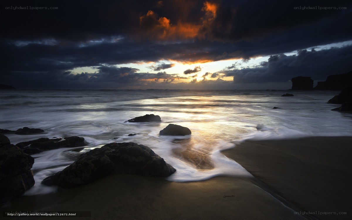 Dramatic sunset over rocky beach