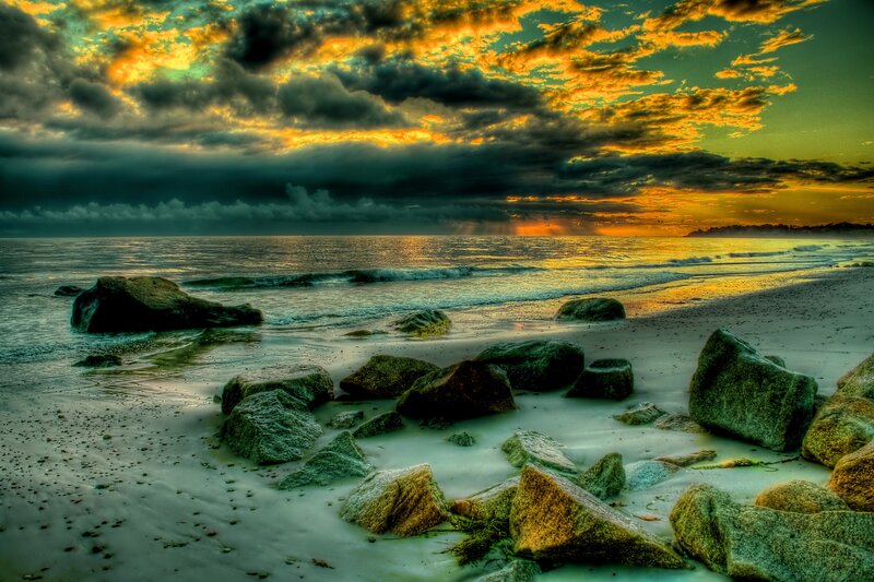 dramatic sunset over rocky beach