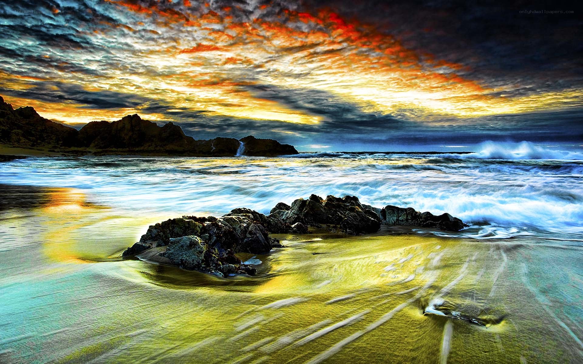 Dramatic sunset over rocky beach