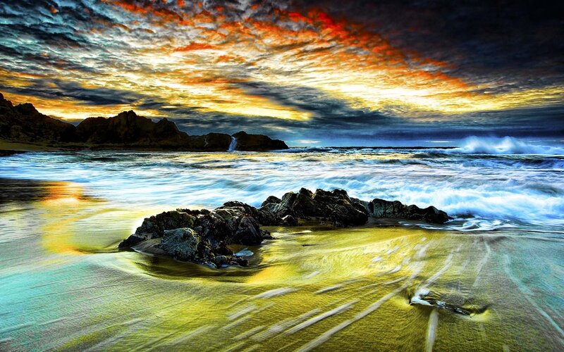 Dramatic sunset over rocky beach
