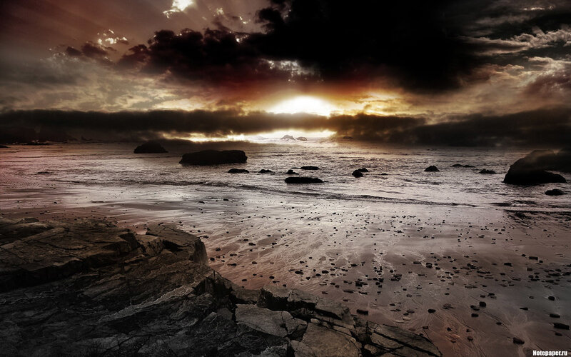 dramatic sunset over rocky beach