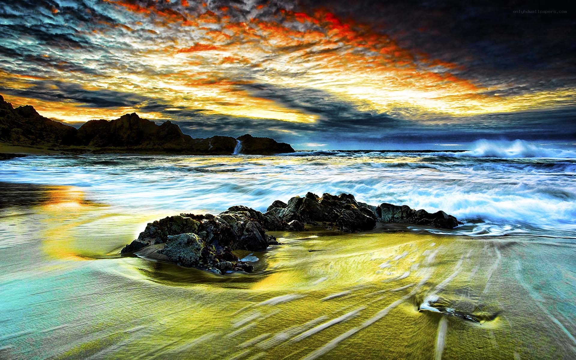 Dramatic sunset over rocky beach