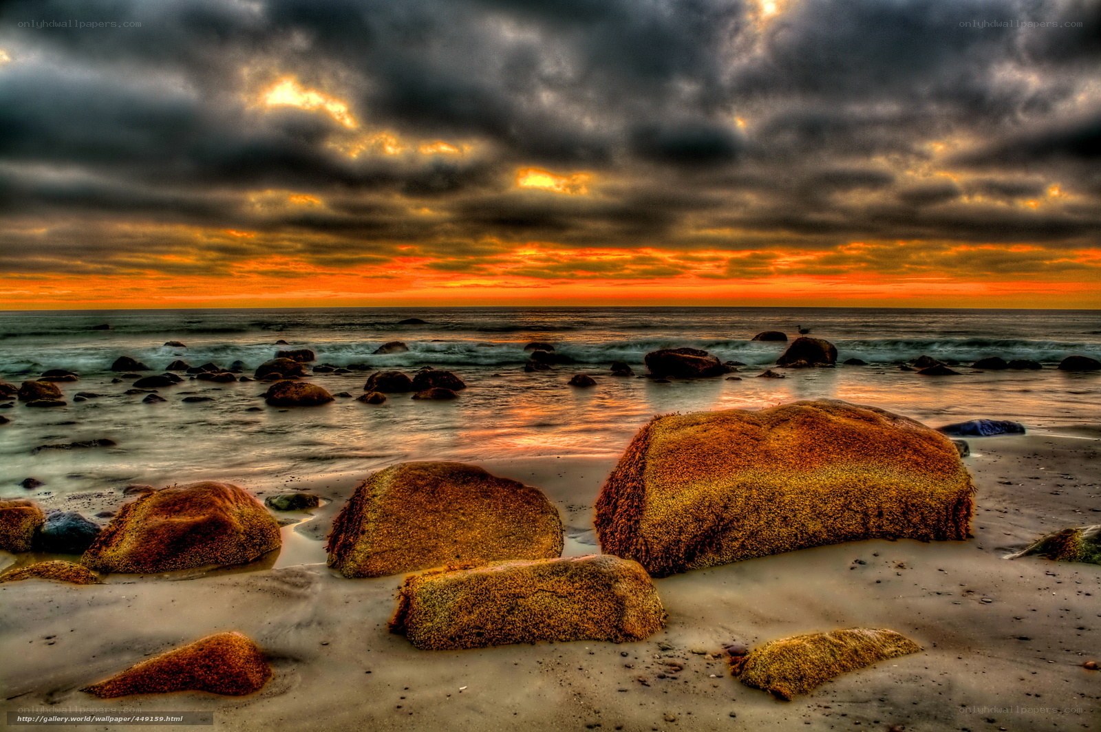 dramatic sunset over rocky beach