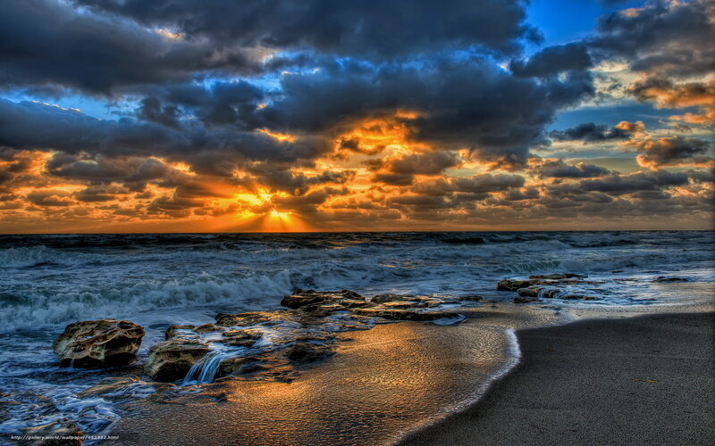dramatic sunset over rocky beach