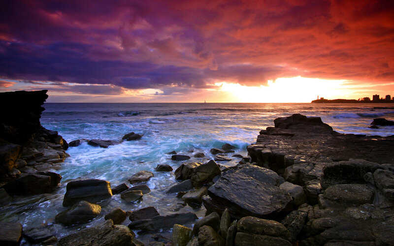 dramatic sunset over rocky coast