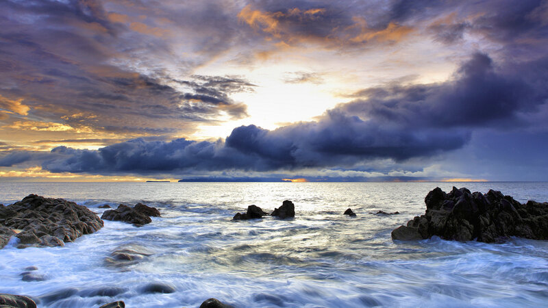 dramatic sunset over rocky coast
