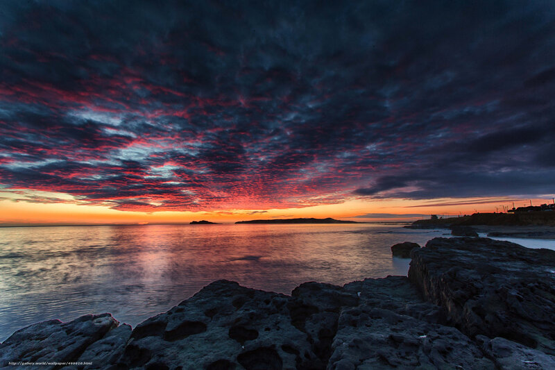 dramatic sunset over rocky coast