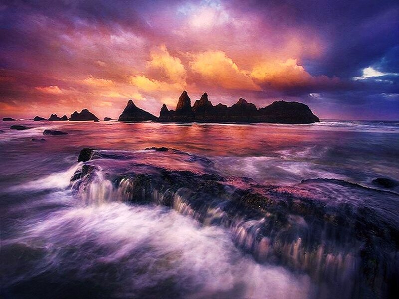 dramatic sunset over rocky coastline