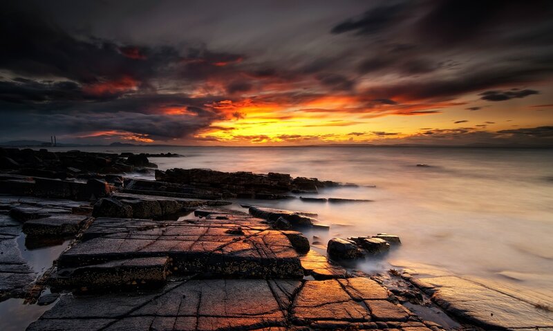 Dramatic sunset over rocky shore