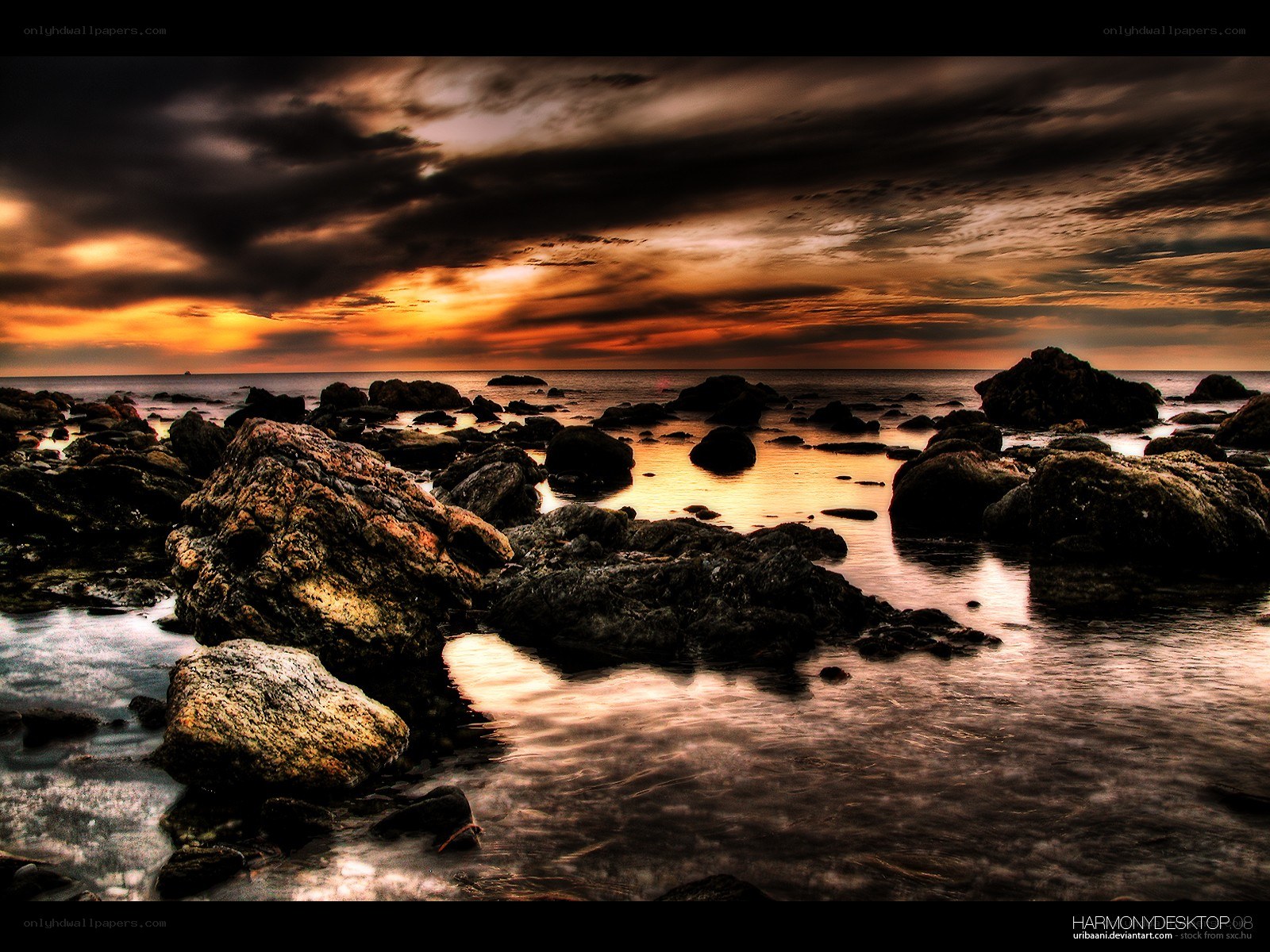 dramatic sunset over rocky shore
