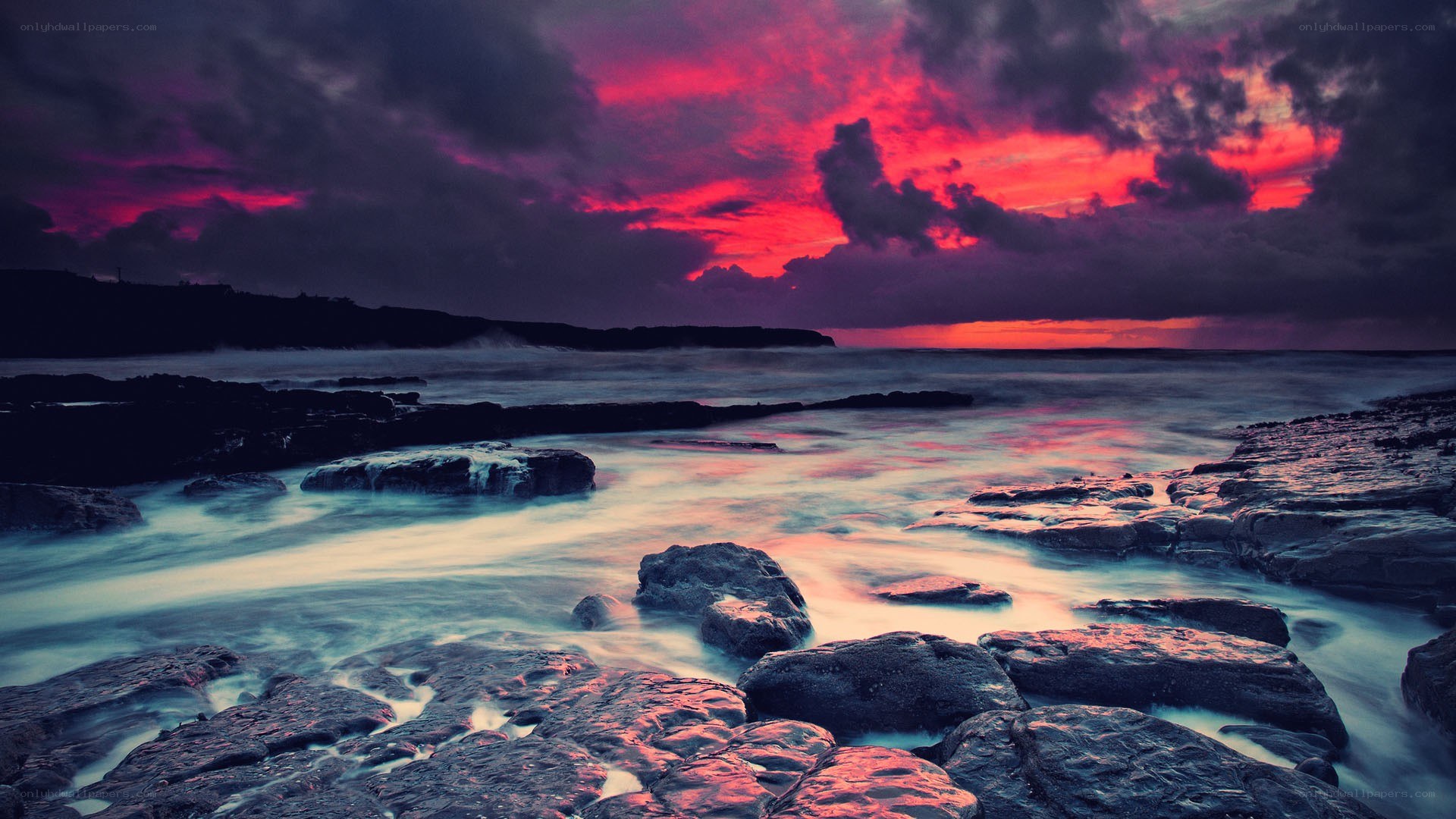 dramatic sunset over rocky shore
