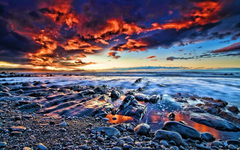 dramatic sunset over rocky shore