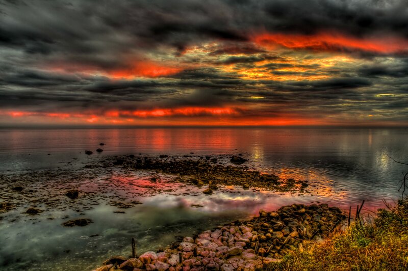 Dramatic sunset over rocky shore