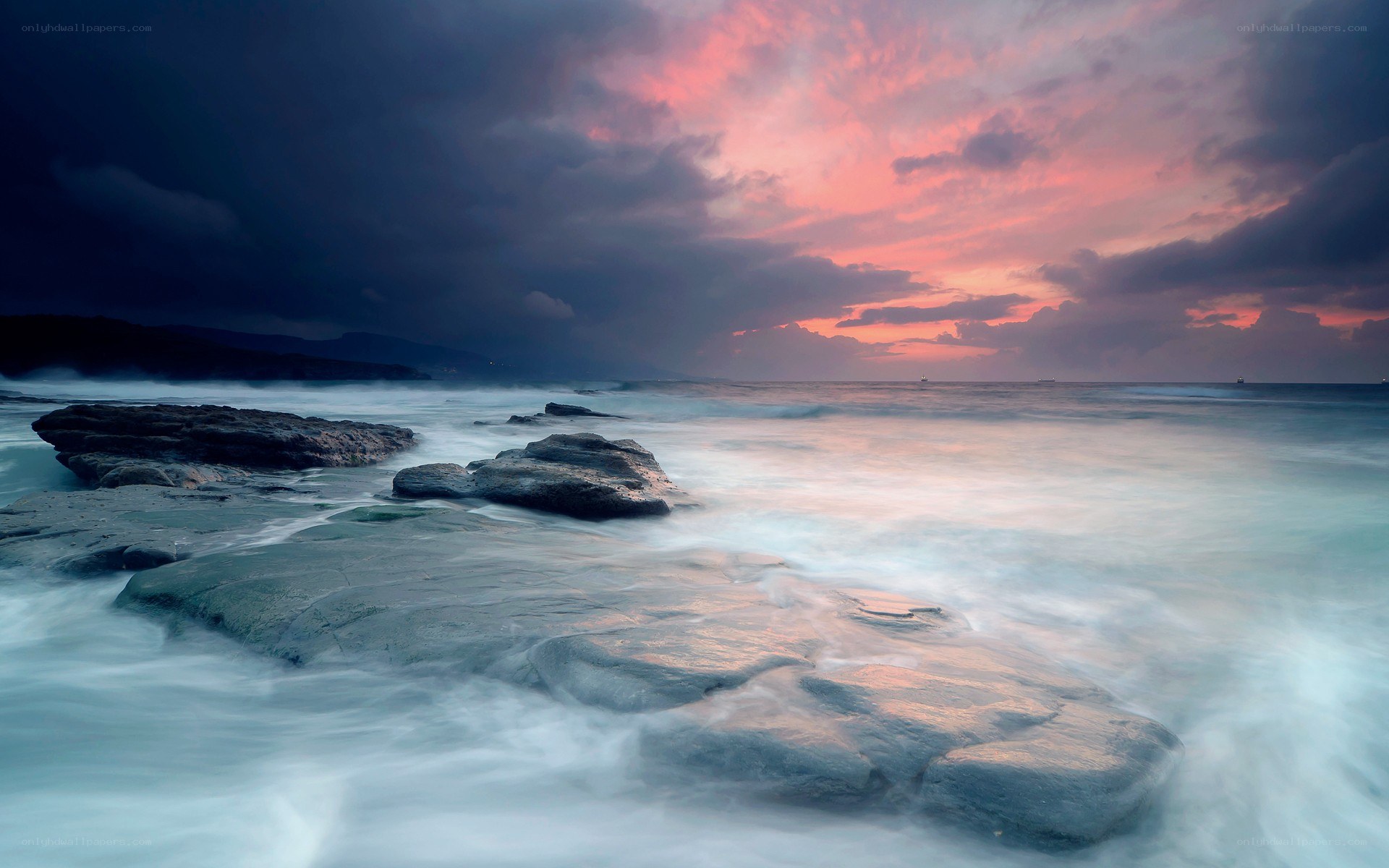 dramatic sunset over rocky shore