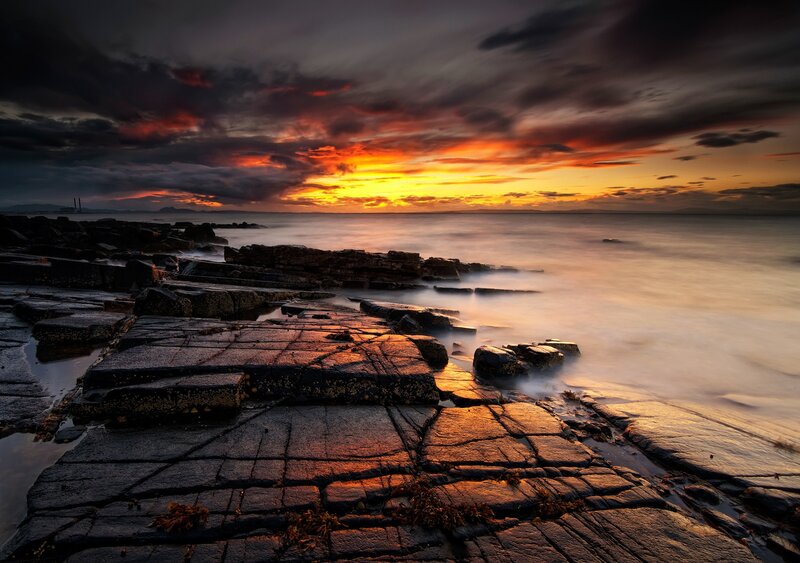 Dramatic sunset over rocky shore