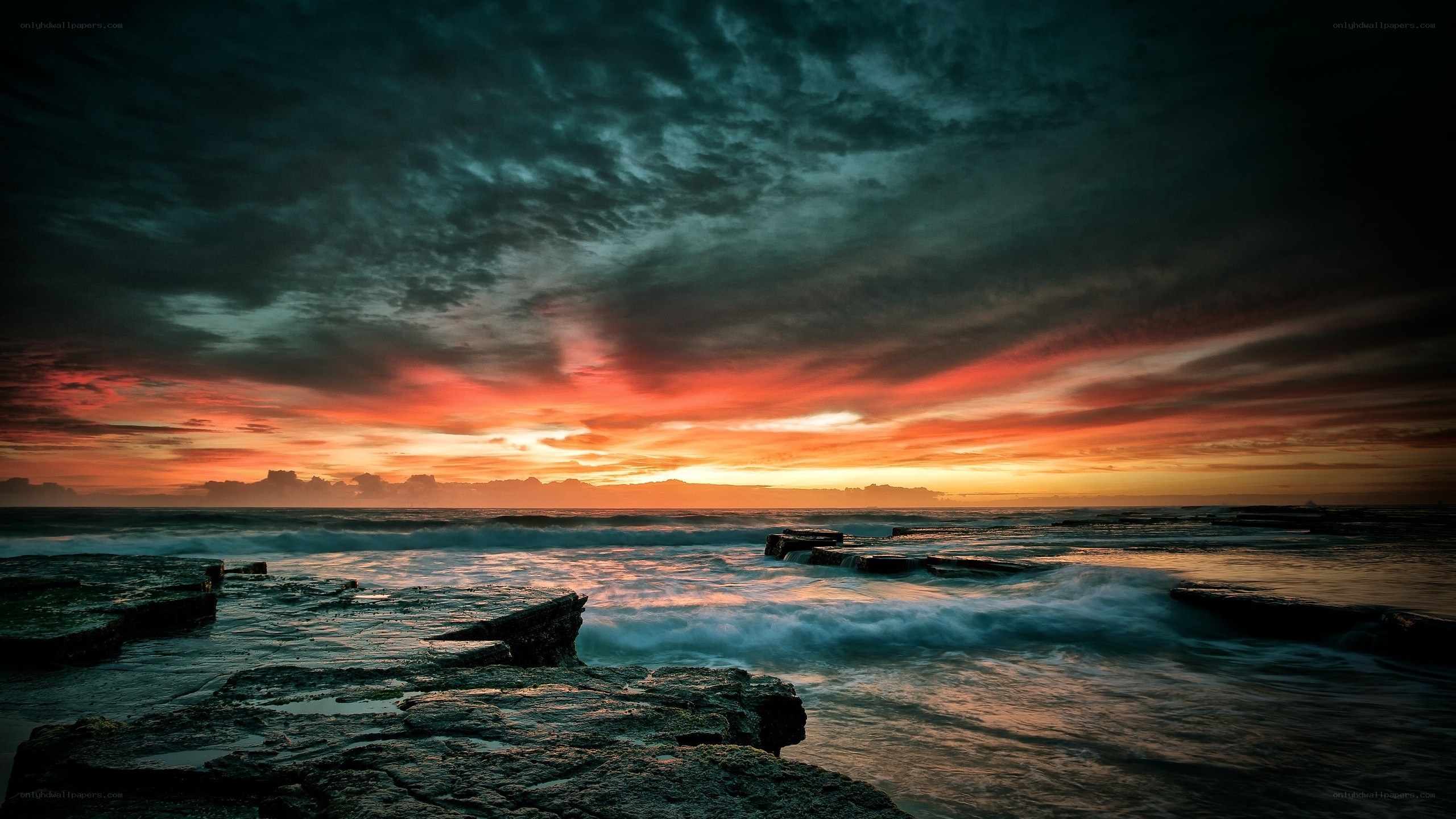 dramatic sunset over rocky shore