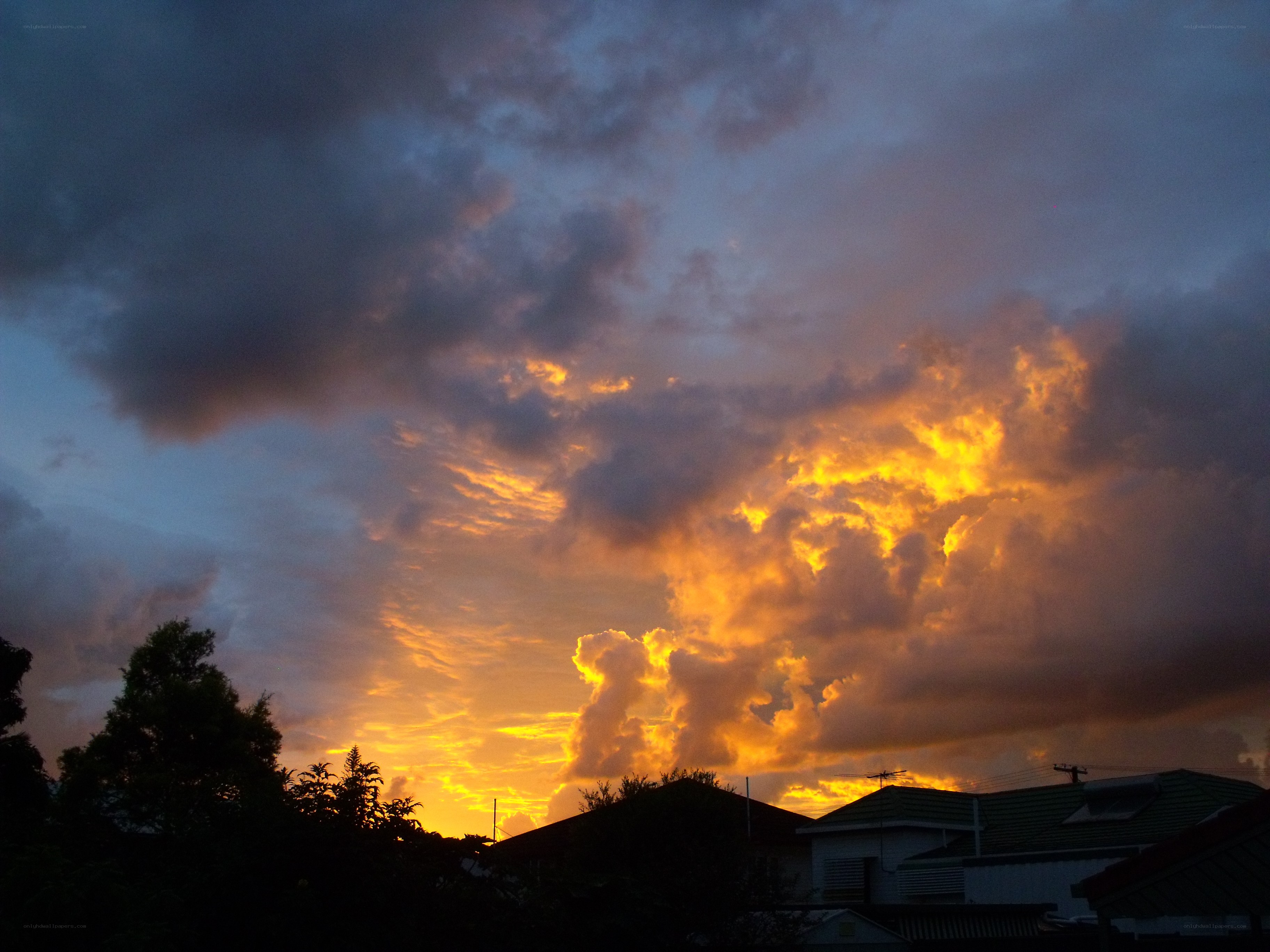 Dramatic sunset over rooftops