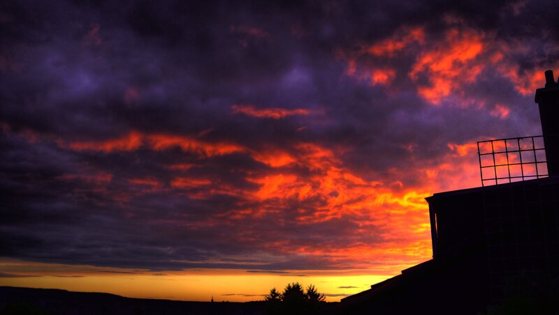 dramatic sunset over rooftops
