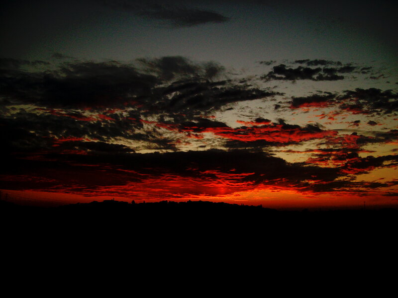 dramatic sunset over silhouetted landscape