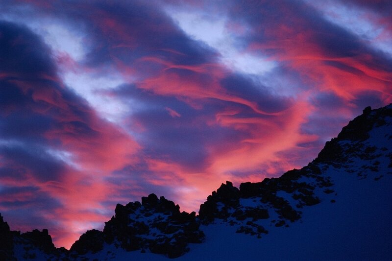 dramatic sunset over snow-capped mountains