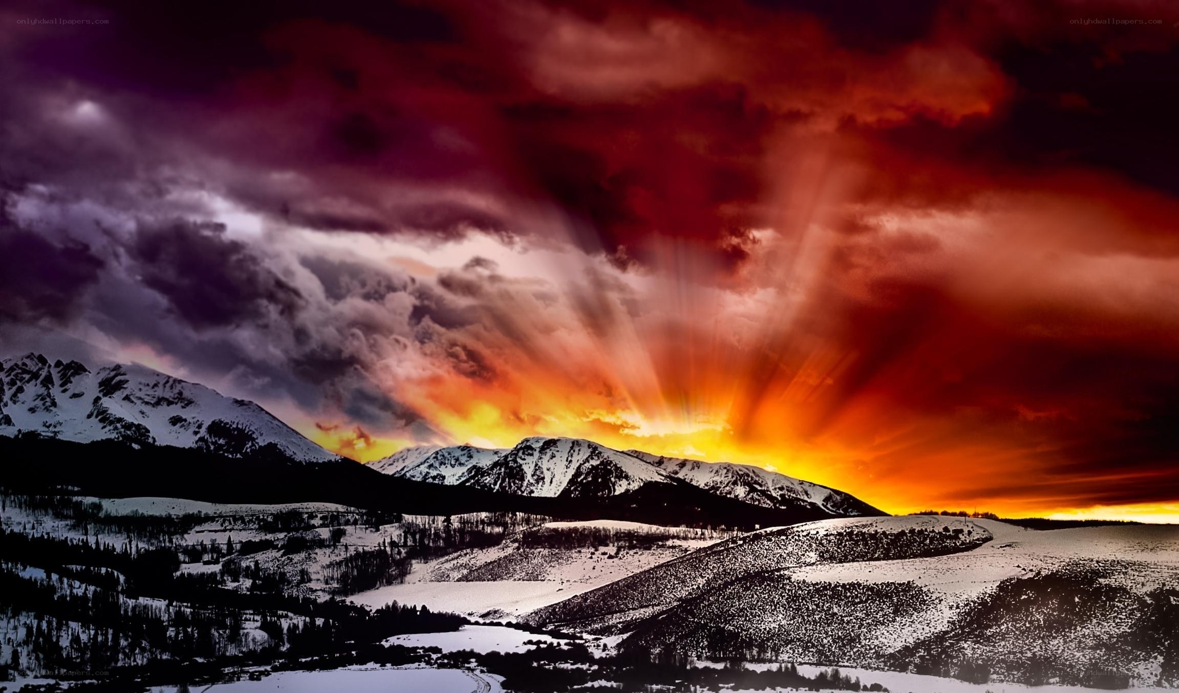 dramatic sunset over snow mountains