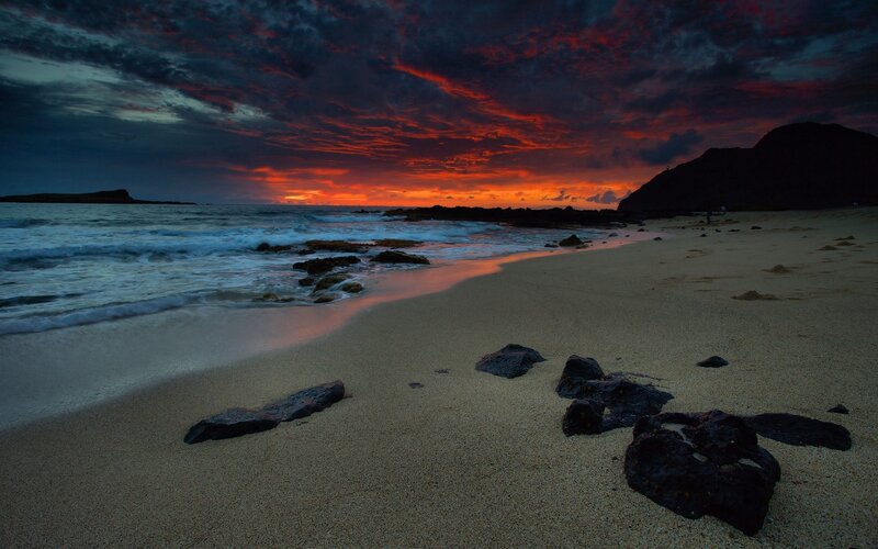 dramatic sunset over volcanic beach