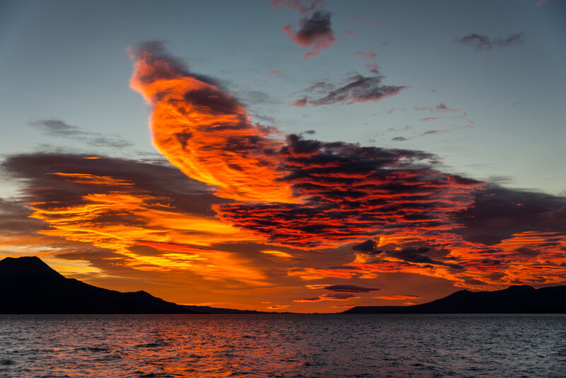Dramatic Sunset over Water — Orange, Photograph, Mountains