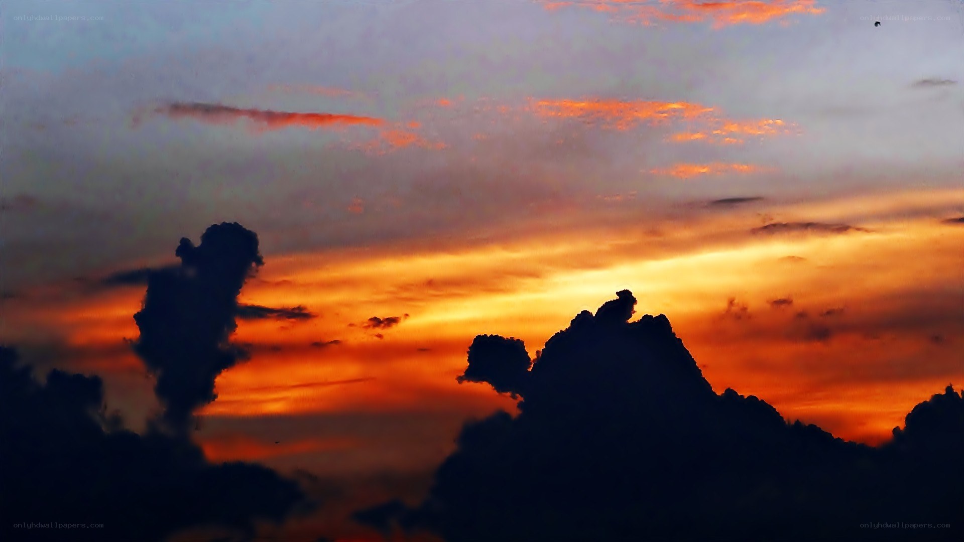 dramatic sunset with silhouetted clouds