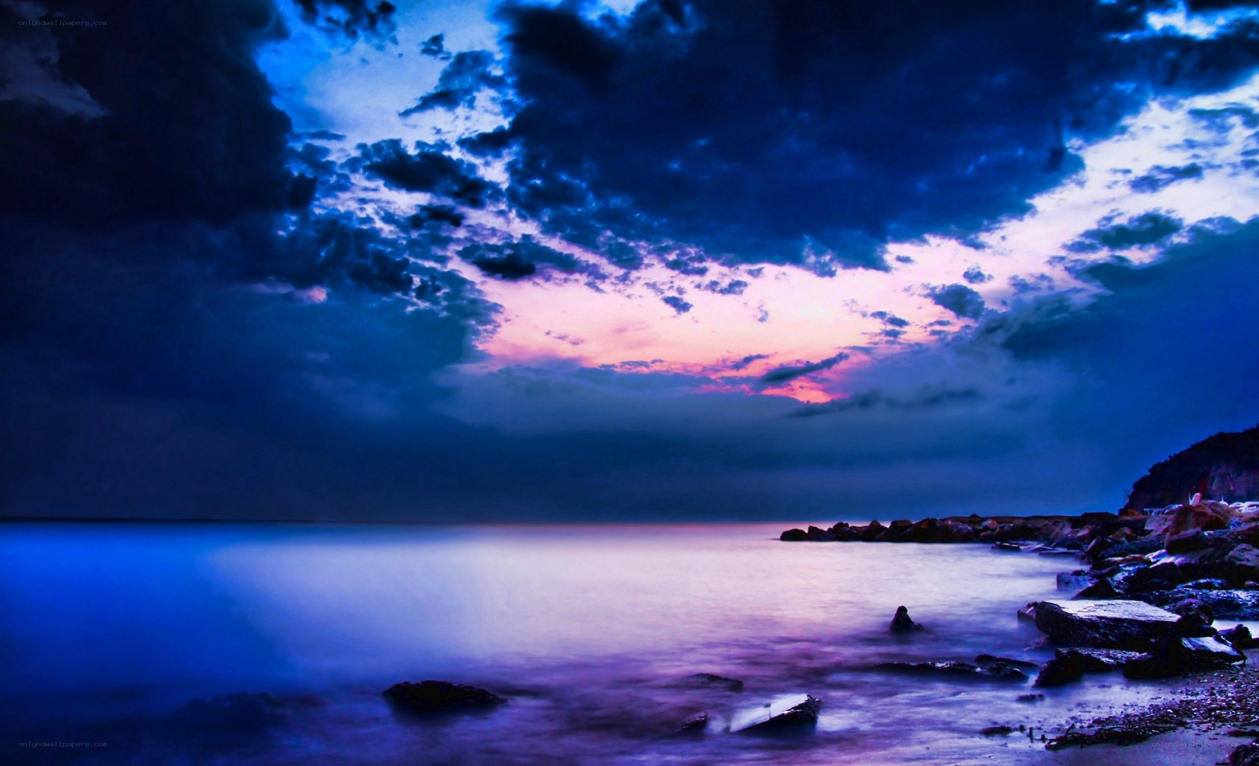 dramatic twilight over rocky shore